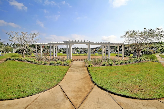 surrounding community with a pergola and a yard