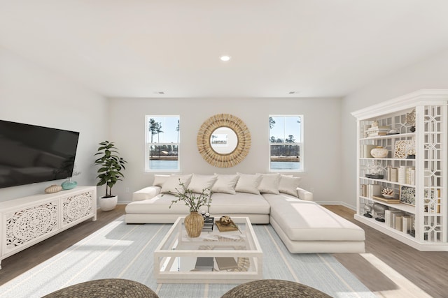 living area featuring recessed lighting, baseboards, and wood finished floors