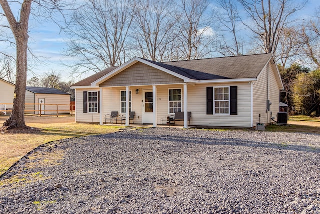 ranch-style home with central AC unit and covered porch