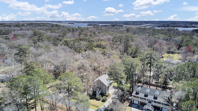 birds eye view of property featuring a view of trees