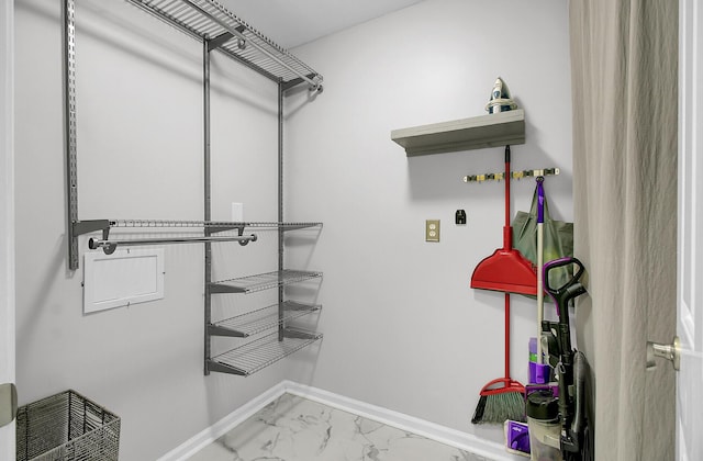 spacious closet featuring marble finish floor