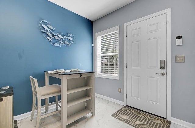 foyer entrance featuring marble finish floor and baseboards