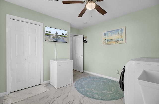 clothes washing area with laundry area, baseboards, and marble finish floor