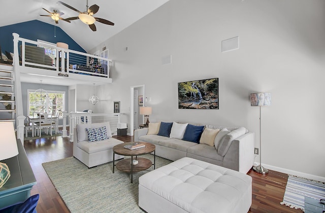 living area featuring high vaulted ceiling, a ceiling fan, baseboards, and wood finished floors