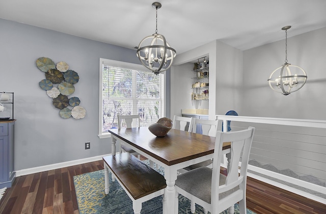 dining space with dark wood-style floors, a notable chandelier, and baseboards