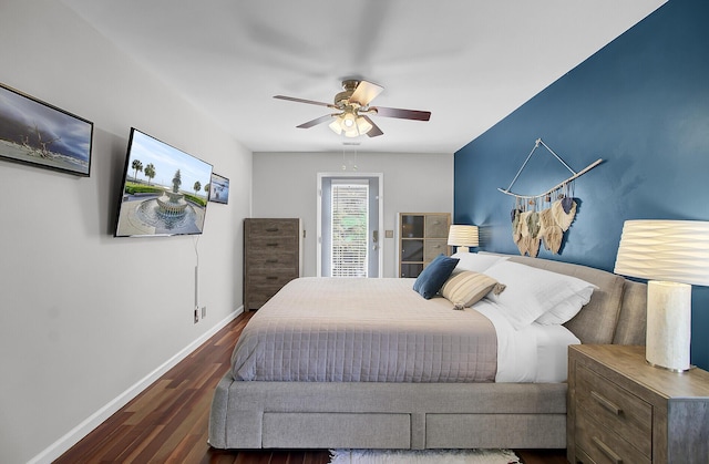 bedroom featuring a ceiling fan, baseboards, and wood finished floors