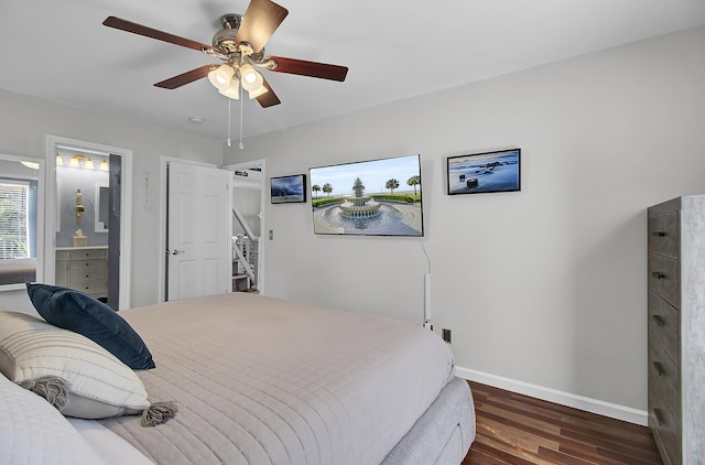 bedroom with a ceiling fan, wood finished floors, baseboards, and ensuite bathroom