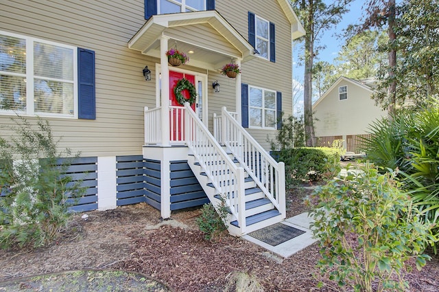 view of exterior entry with fence