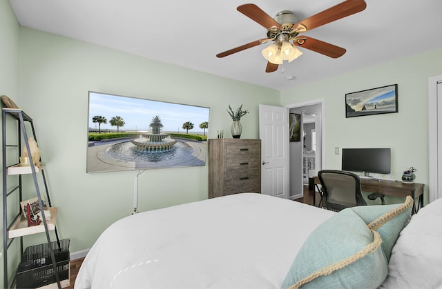 bedroom featuring wood finished floors, a ceiling fan, and baseboards