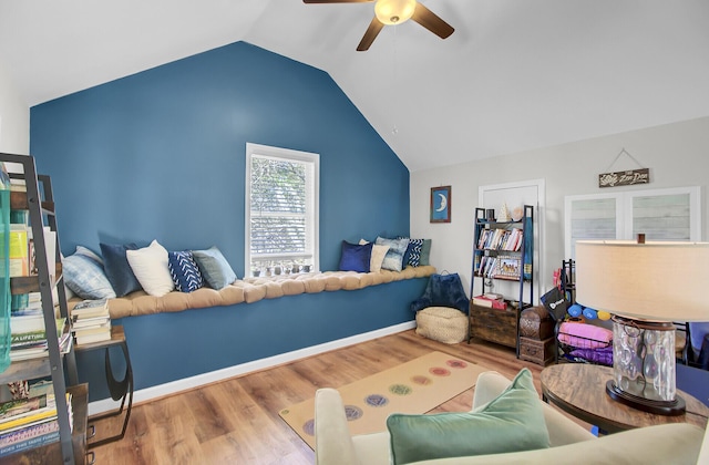 bedroom featuring a ceiling fan, vaulted ceiling, wood finished floors, and baseboards