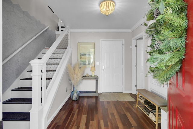 entrance foyer featuring stairway, crown molding, baseboards, and wood finished floors