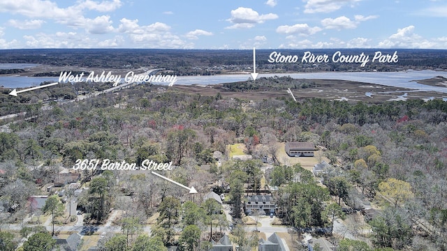 aerial view featuring a forest view and a water view