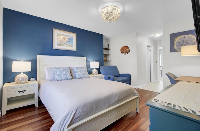 bedroom featuring wood finished floors and baseboards