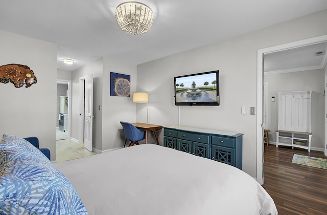 bedroom with wood finished floors and baseboards