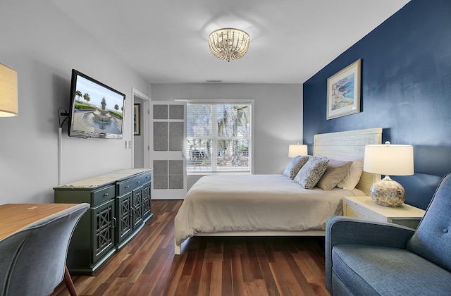 bedroom with dark wood finished floors