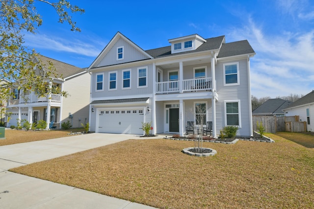 view of front of house featuring a balcony, a garage, covered porch, driveway, and a front lawn