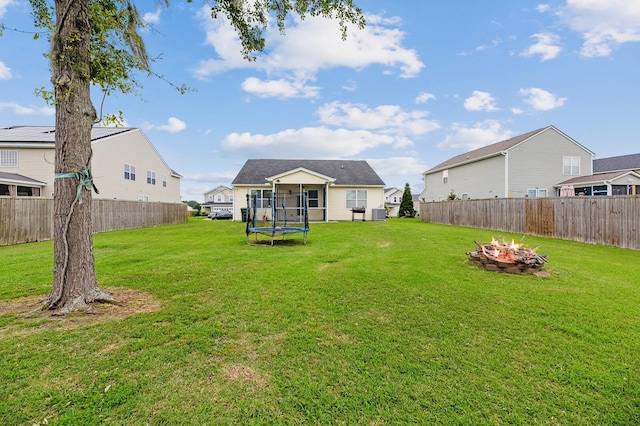 405 Watershed Dr, Goose Creek, SC 29445 - rear view of house featuring a trampoline and an outdoor fire pit