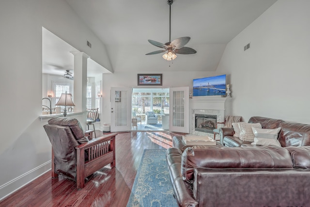 living room featuring wood-type flooring, high vaulted ceiling, and ceiling fan