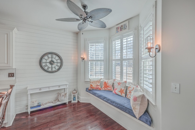 sitting room featuring dark wood-type flooring and ceiling fan