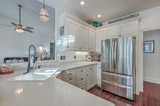 kitchen featuring stainless steel refrigerator, tasteful backsplash, sink, white cabinets, and dark hardwood / wood-style flooring