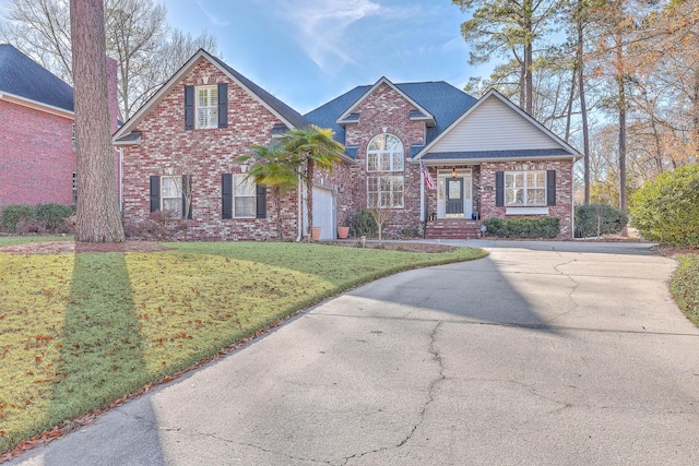 front of property with a garage and a front lawn