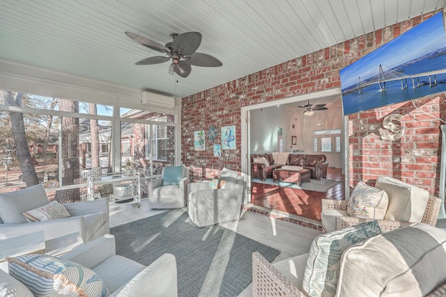 sunroom featuring ceiling fan, a healthy amount of sunlight, and a wall unit AC