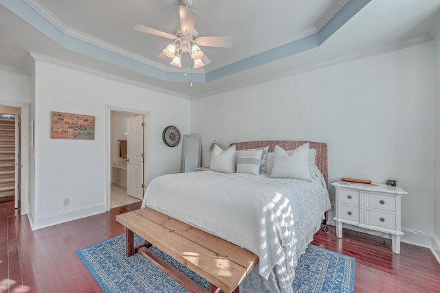 bedroom with hardwood / wood-style flooring, ceiling fan, crown molding, and a raised ceiling