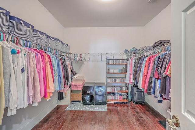 walk in closet featuring dark hardwood / wood-style flooring