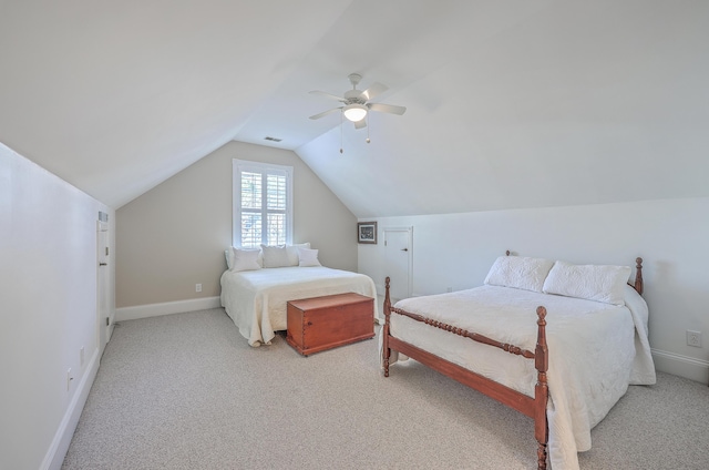 carpeted bedroom with vaulted ceiling and ceiling fan