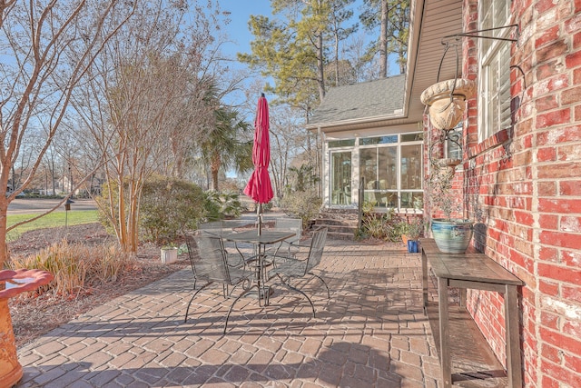 view of patio / terrace featuring a sunroom