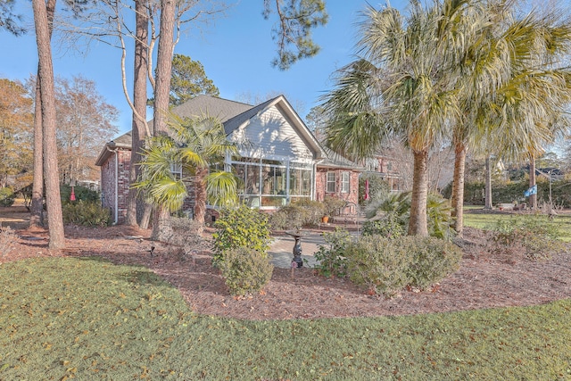 back of house featuring a lawn