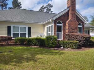 exterior space with a lawn and a chimney