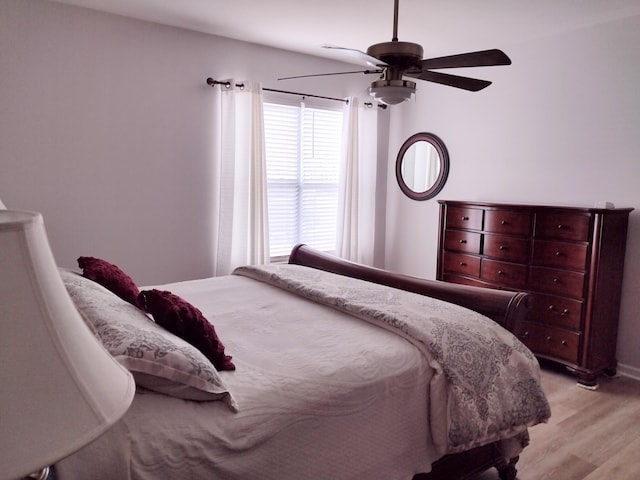 bedroom with light wood-type flooring and ceiling fan