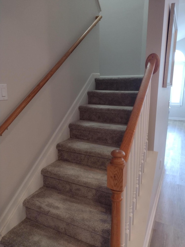 stairway featuring wood finished floors