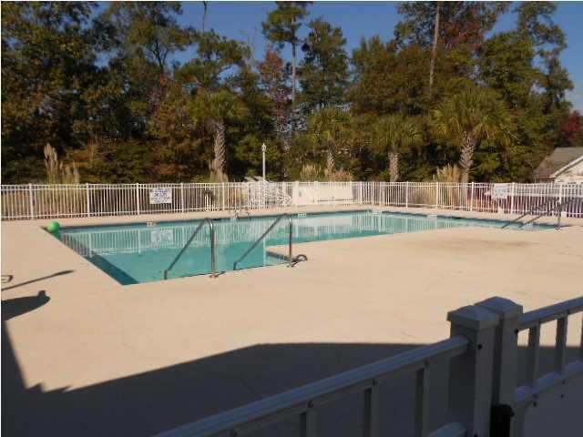 community pool featuring fence and a patio area