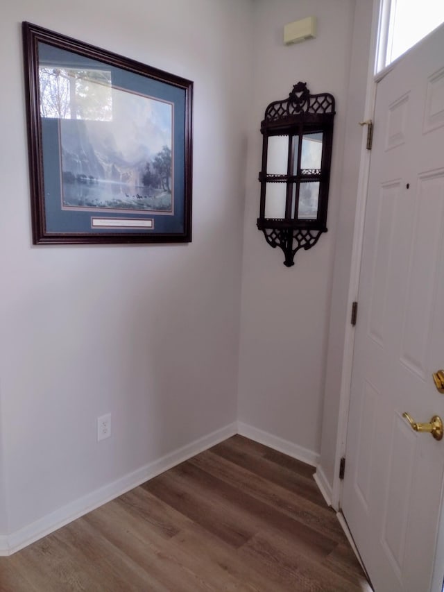 unfurnished room featuring baseboards and wood finished floors