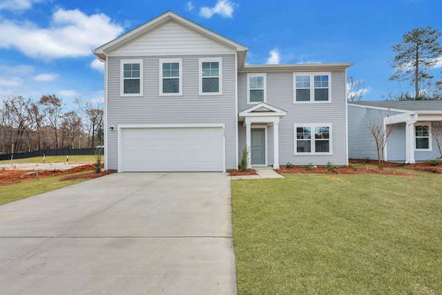 view of front of property featuring a front yard and a garage