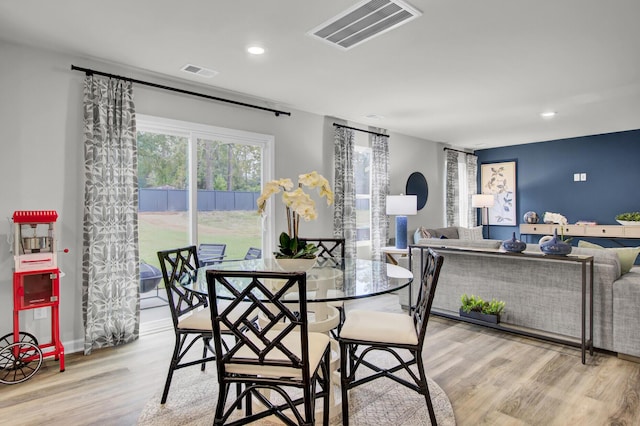 dining area featuring light wood-type flooring and a wealth of natural light