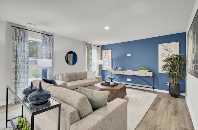 living room with plenty of natural light and hardwood / wood-style flooring