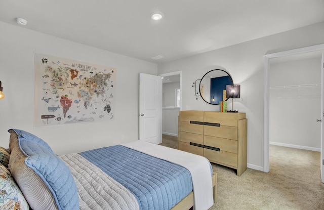 bedroom featuring a closet and light carpet