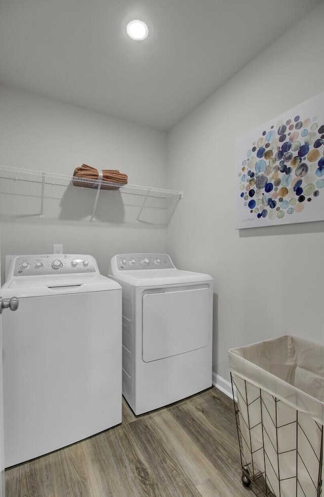 washroom featuring independent washer and dryer and wood-type flooring