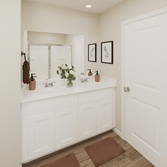 bathroom featuring a shower with door, wood-type flooring, and vanity