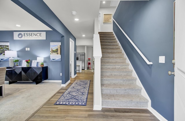 staircase with wood-type flooring