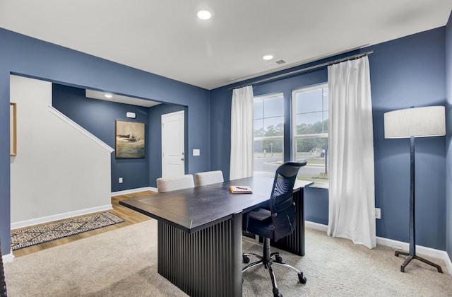 home office with light hardwood / wood-style floors