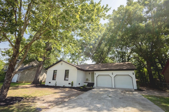 ranch-style house with a garage, concrete driveway, crawl space, and brick siding