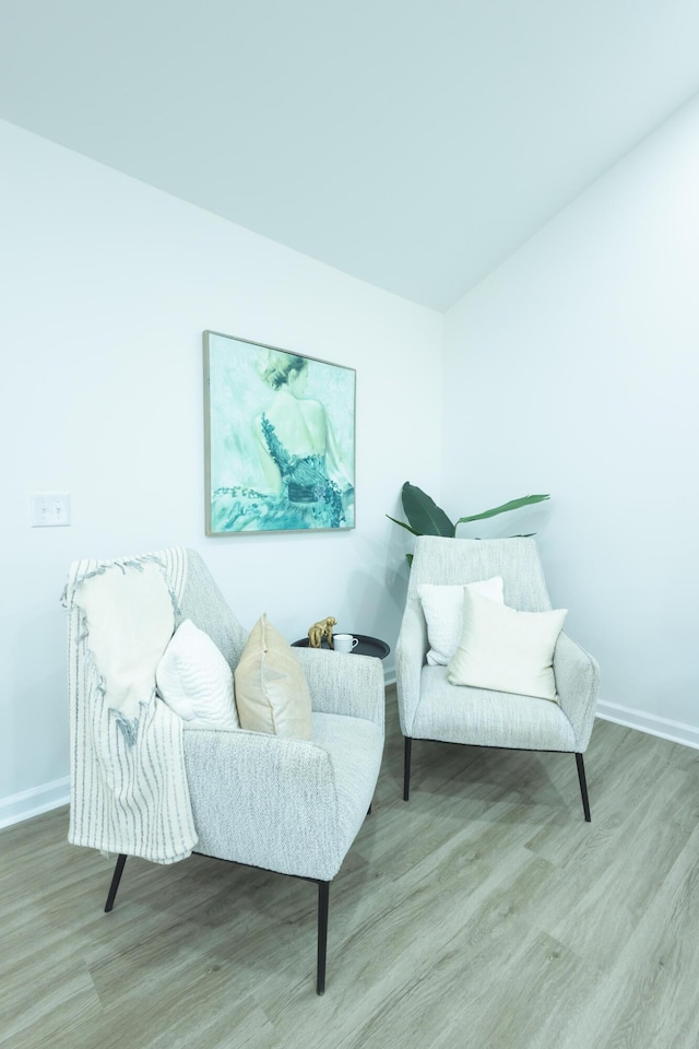 sitting room with wood finished floors and baseboards