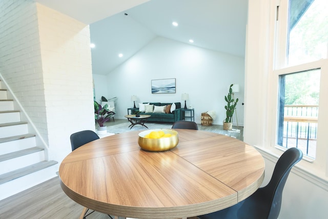 dining space featuring stairway, recessed lighting, wood finished floors, and vaulted ceiling