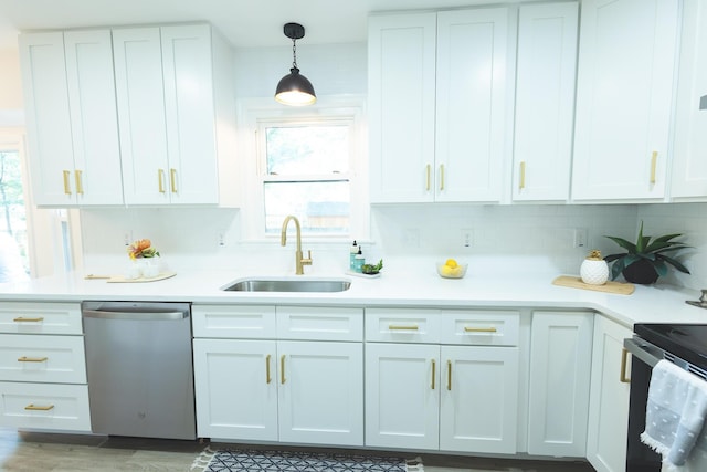 kitchen with stainless steel dishwasher, a sink, light countertops, and tasteful backsplash