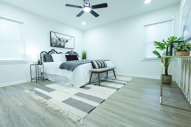 bedroom with wood finished floors, baseboards, recessed lighting, and a ceiling fan