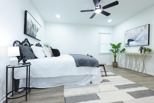 bedroom featuring wood finished floors, baseboards, recessed lighting, and ceiling fan